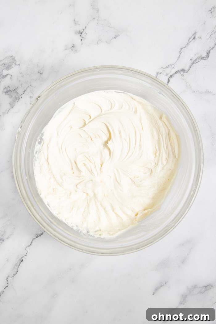 Smooth vanilla buttercream frosting in a mixing bowl.
