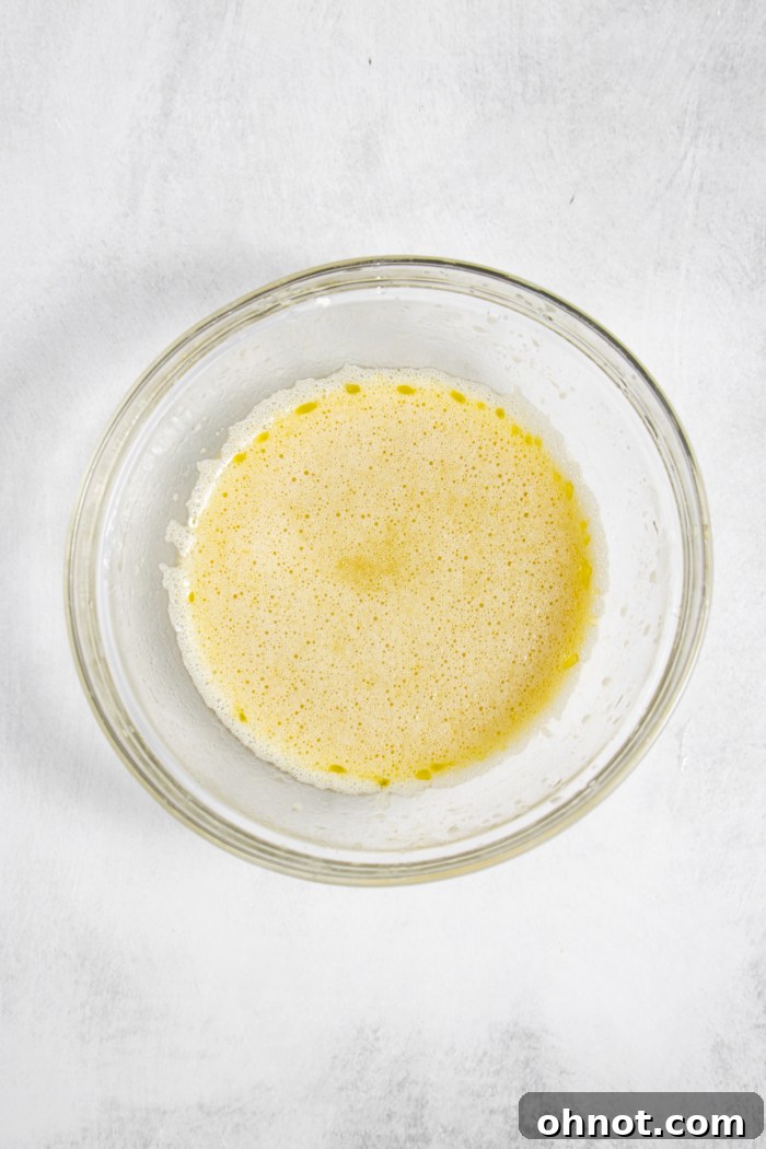 Melted dairy-free butter or oil in a bowl, ready to be mixed.
