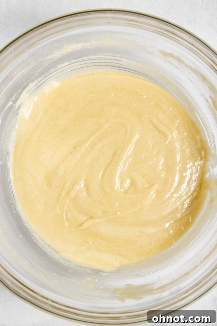 Smooth cupcake batter in a mixing bowl, perfectly combined.