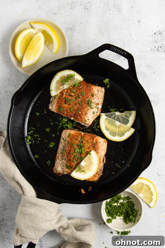 Skillet with salmon fillets.