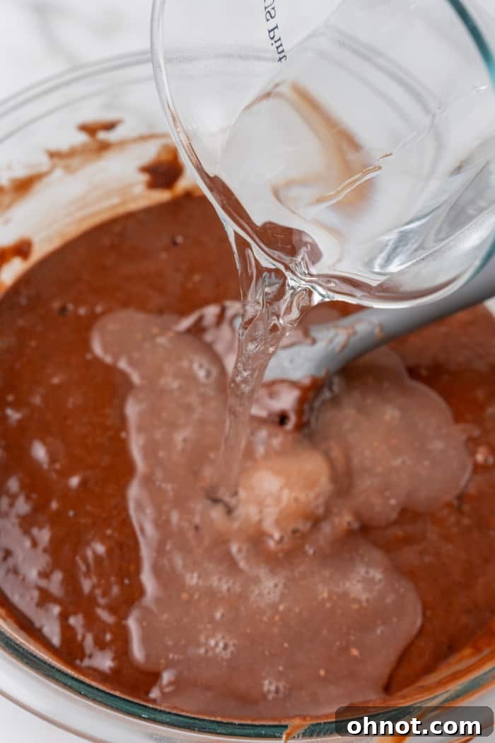 Hot water poured into batter.