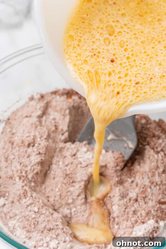 Whisked eggs poured into bowl.