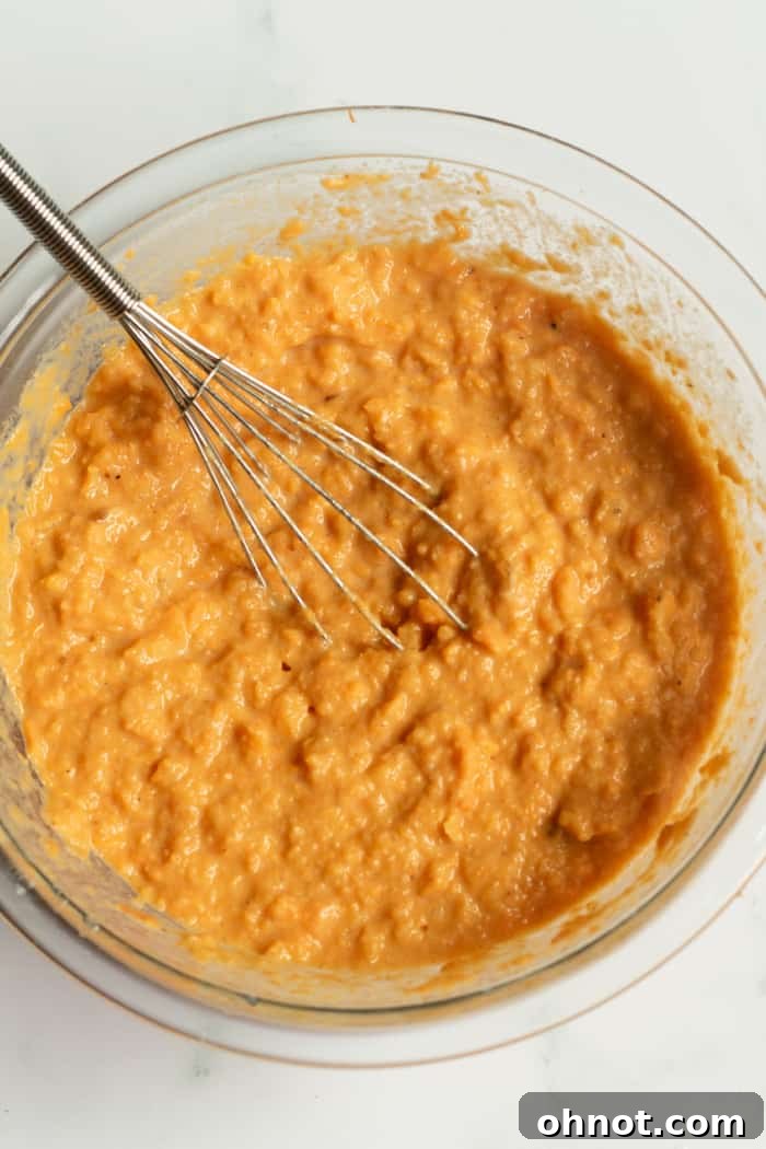 Smooth sweet potato pie filling mixture in a large bowl.