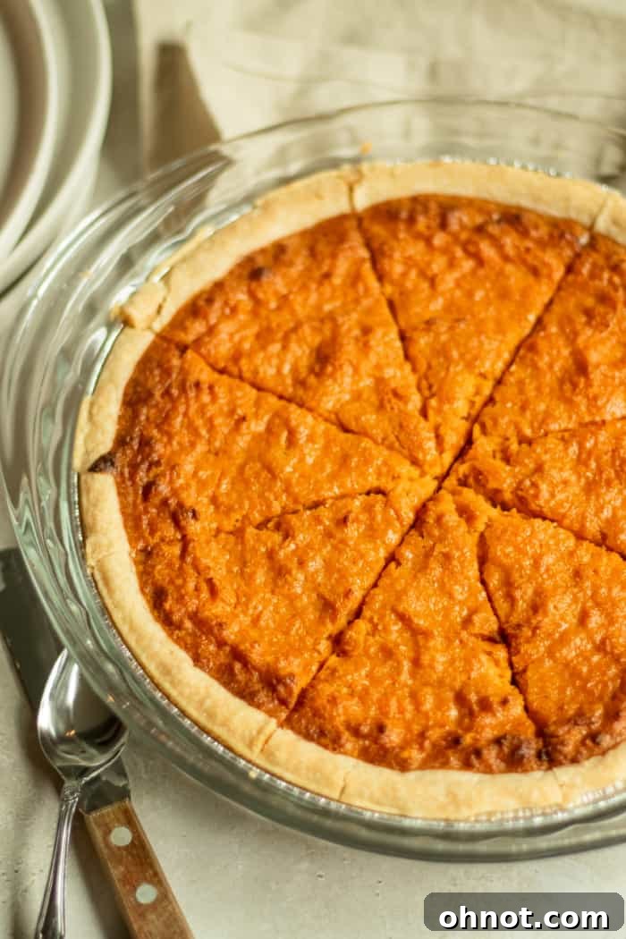 A freshly baked sweet potato pie cooling on a wire rack.