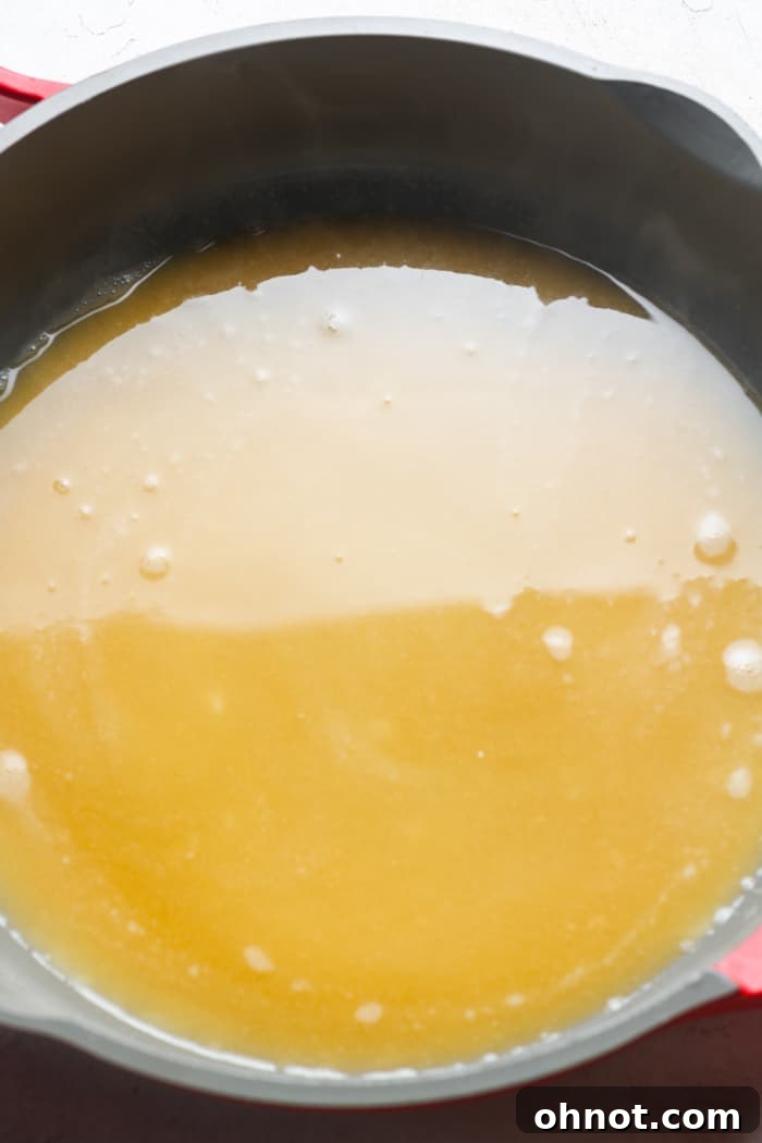 Savory brown gravy simmering in a skillet.