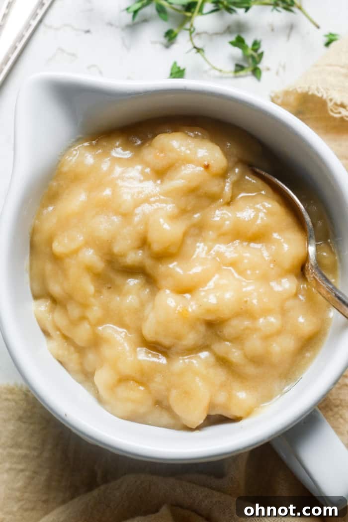 Rich, homemade gluten-free gravy in a white serving bowl.