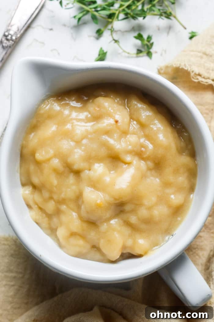 A bowl of chunky brown sauce, possibly gravy or a similar condiment.