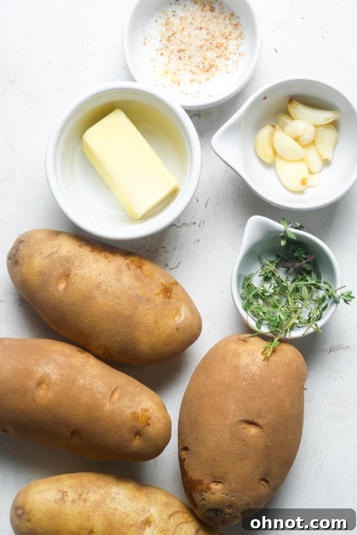 Fresh ingredients for making vegan mashed potatoes, including potatoes, garlic, and vegan butter.