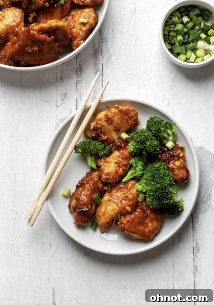 Delicious Whole30 Orange Chicken served with fresh broccoli florets, showcasing its vibrant orange sauce and tender chicken pieces.