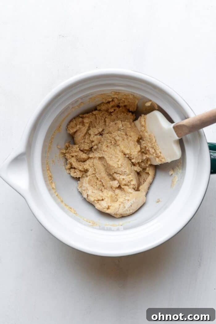 Close-up of almond flour Paleo Snickerdoodle cookie dough being mixed in a bowl.