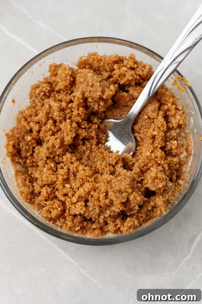 Buttery graham cracker crust mixture in a bowl.