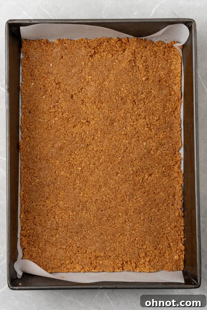 Graham cracker crust pressed into a baking pan.