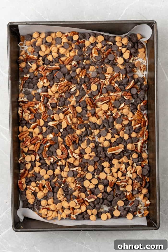 Chocolate chips and chopped pecans layered in the pan.