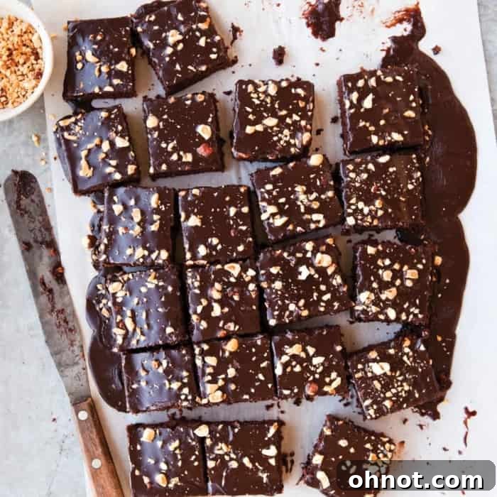 A large chocolate frosted cake, perfectly smooth and ready for decoration or serving.