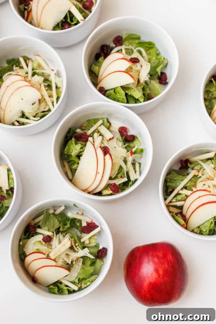 Fresh apple salad with crisp, white apple slices served in elegant bowls.