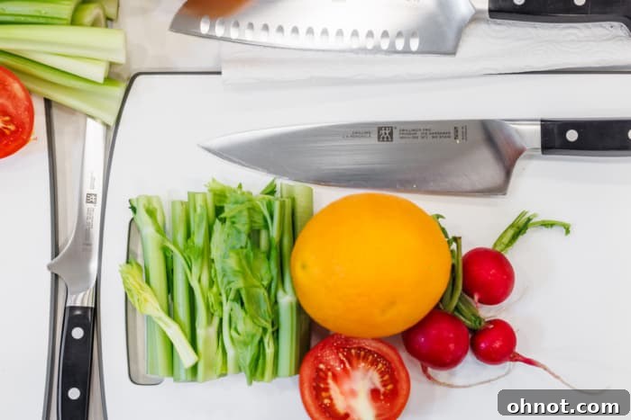Zwilling knives displayed alongside fresh fruits and vegetables.