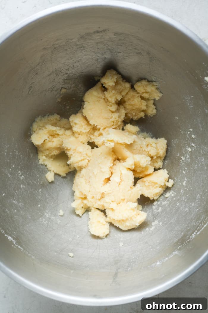 Beaten cold butter with granulated sugar and light brown sugar, showing a creamy, light texture.