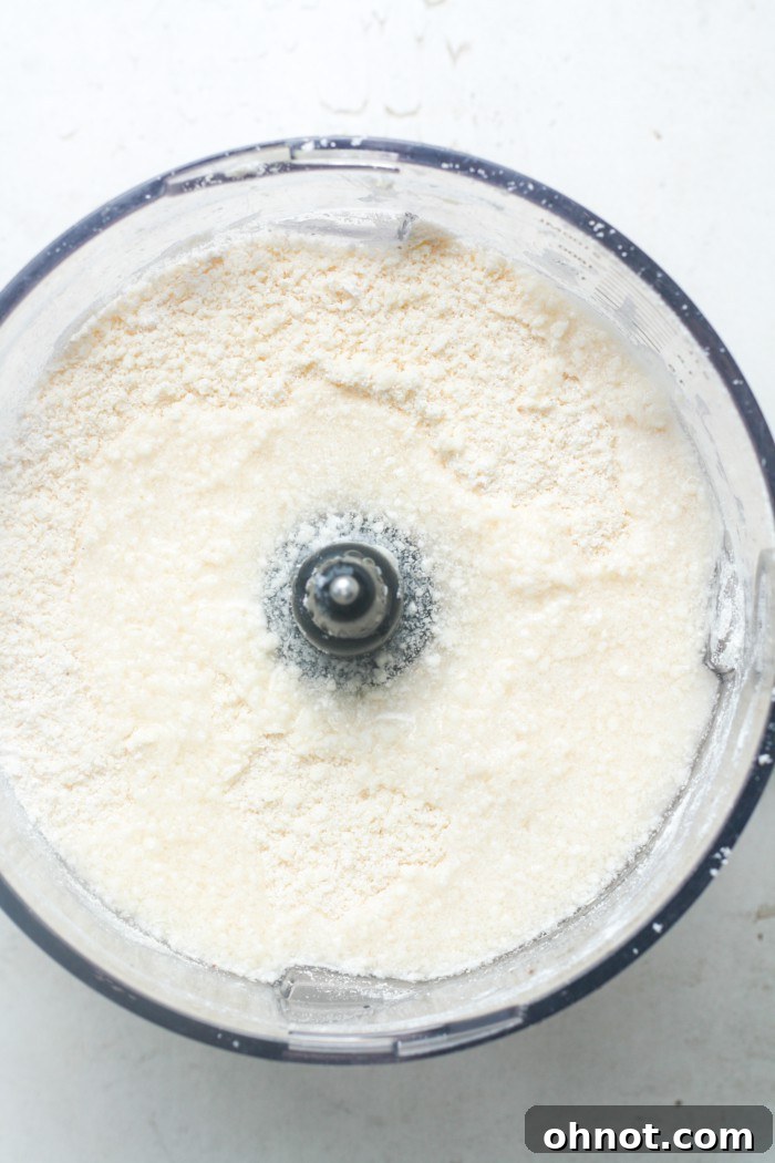Adding water to the flour and butter mixture in the food processor.