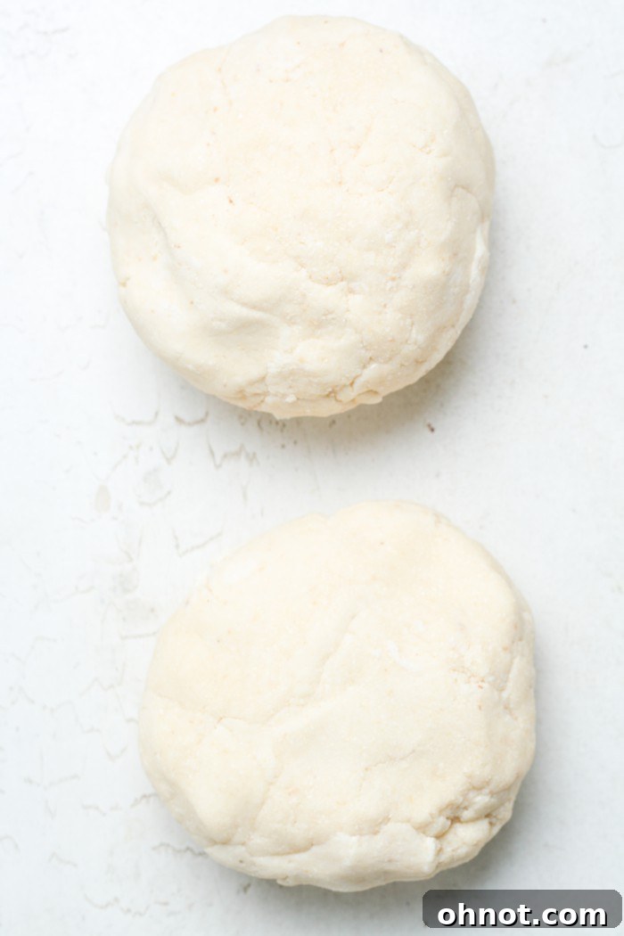 Two flattened discs of dough ready for chilling.