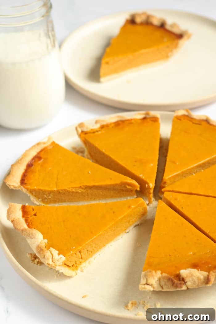 Beautifully sliced healthy pumpkin pie, revealing its creamy texture and golden crust.