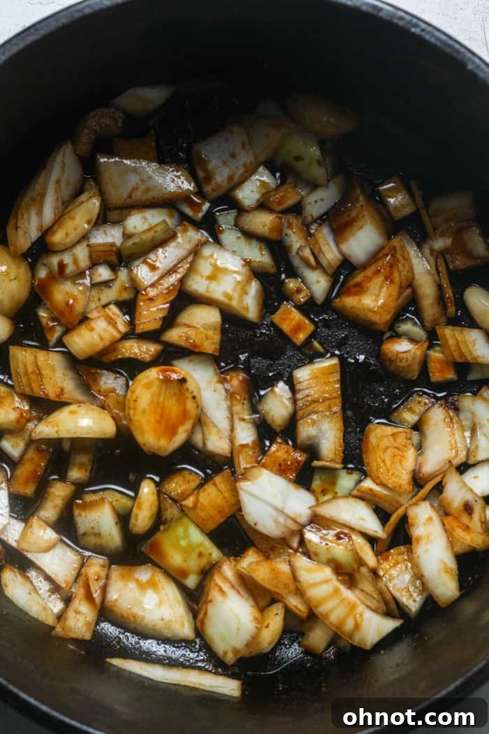 Onions and garlic sautéing in the Dutch oven, releasing their aroma.