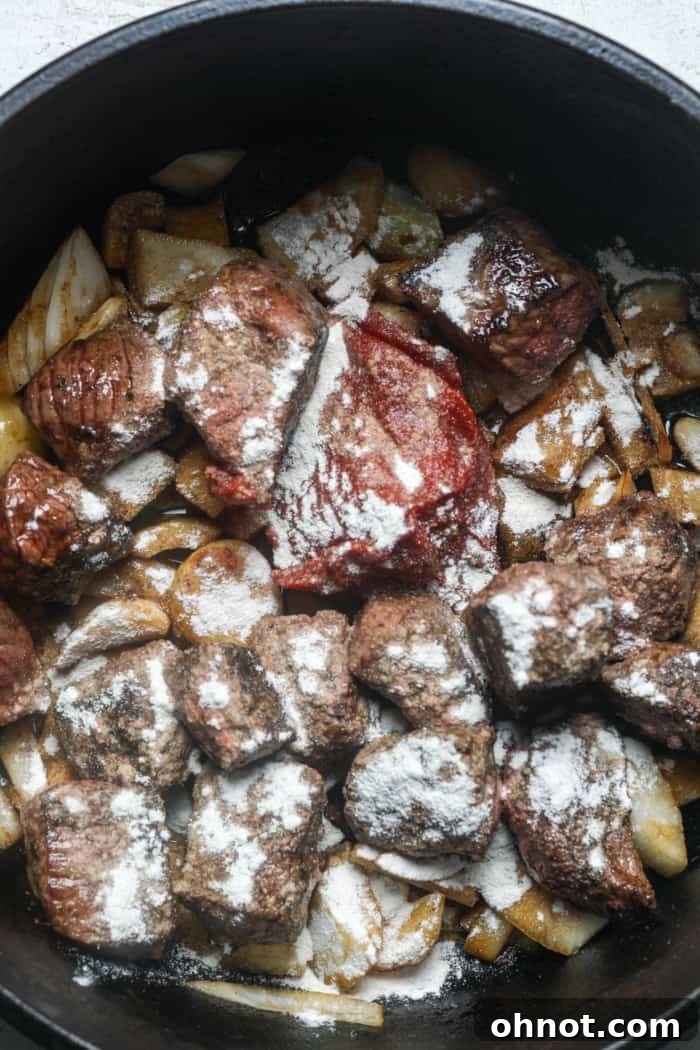 Meat and onions combined in the Dutch oven.