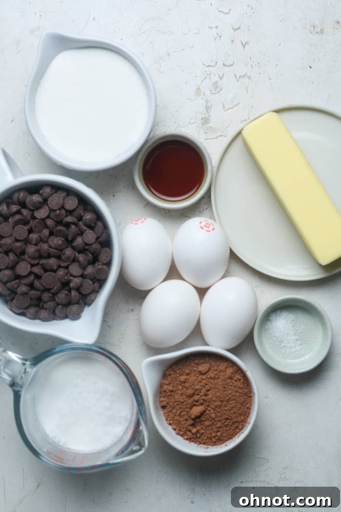 Various ingredients for a flourless chocolate torte arranged on a surface.