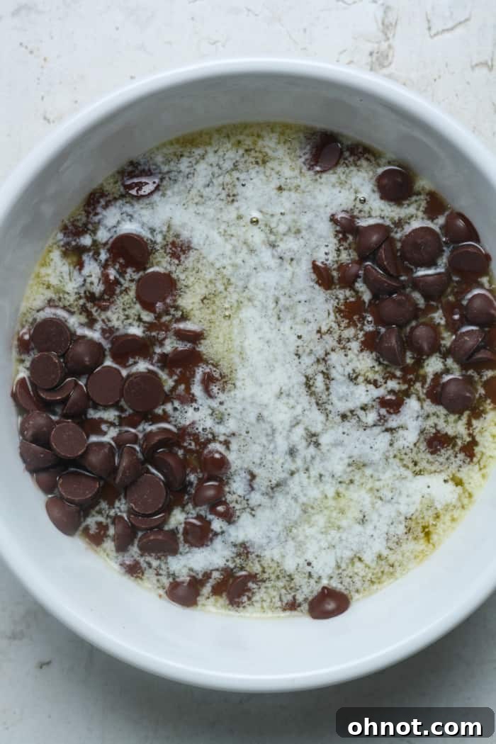 Melted butter and chocolate chips forming a smooth mixture.