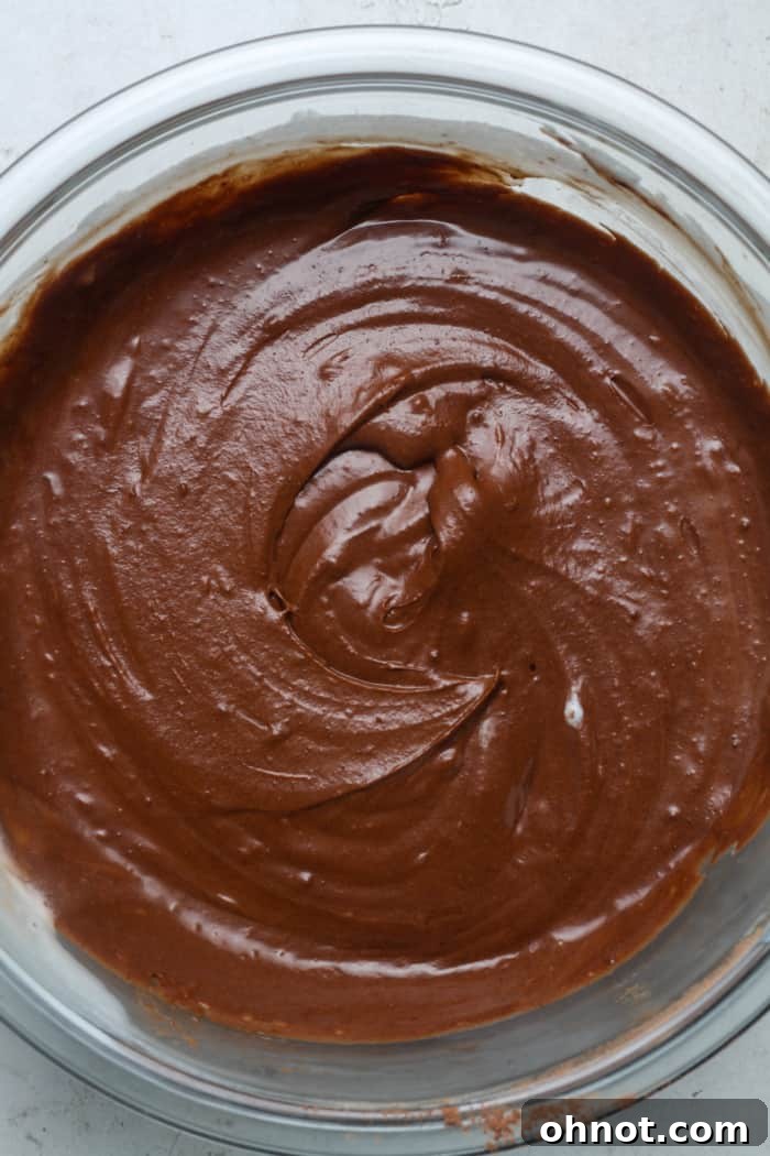 Thick, glossy chocolate batter after whipped cream has been folded in.