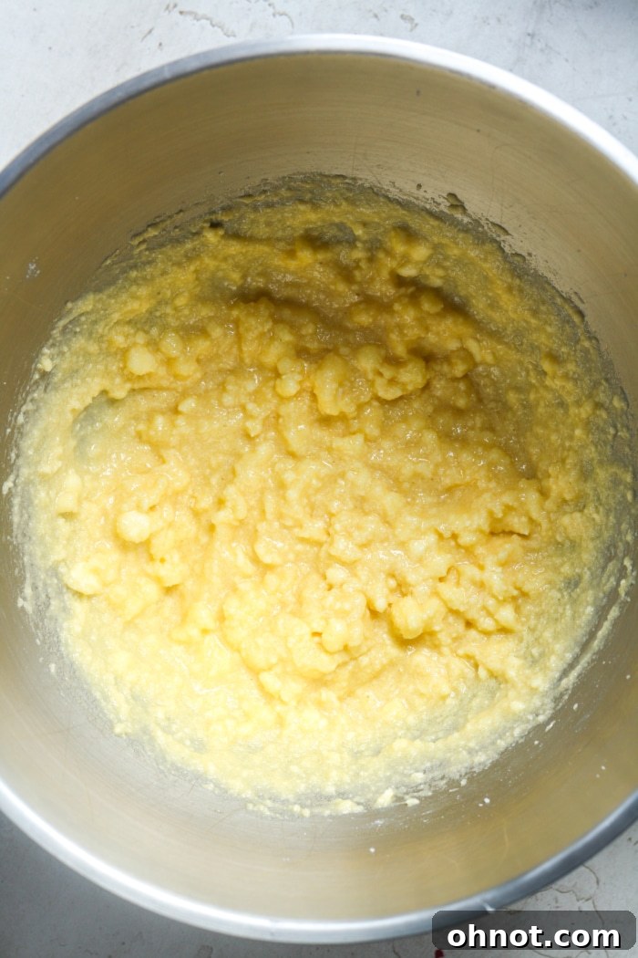 Smooth and creamy yellow cookie dough mixture after adding eggs and vanilla.