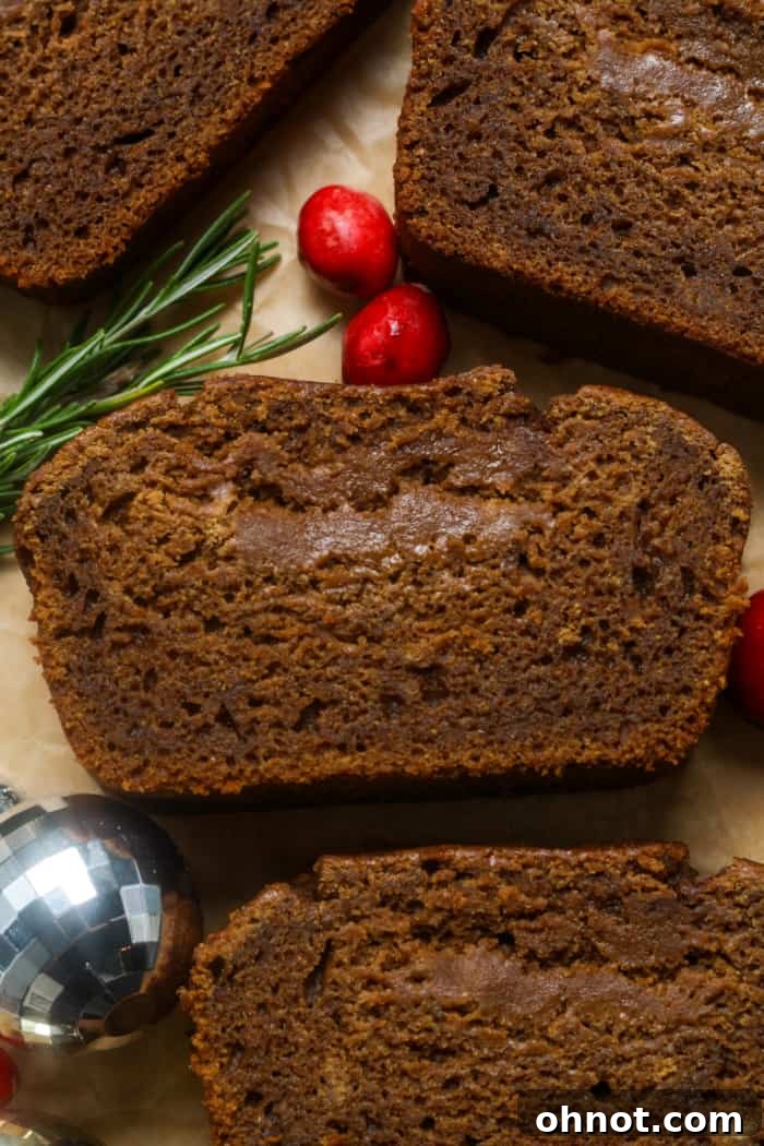 A close-up of a warm, gooey slice of molasses bread, highlighting its moist texture.