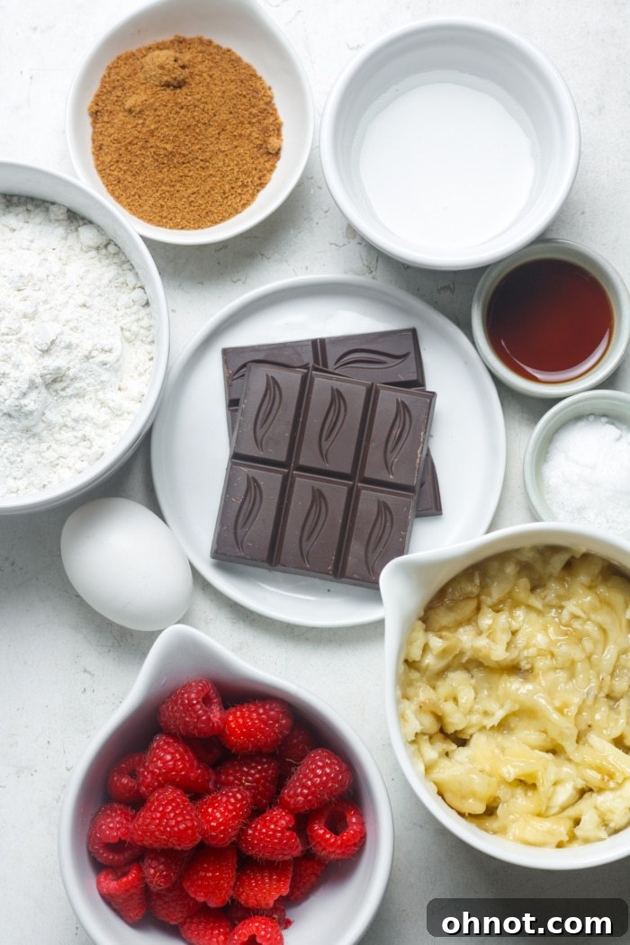 All the fresh ingredients for raspberry bread laid out on a wooden surface.