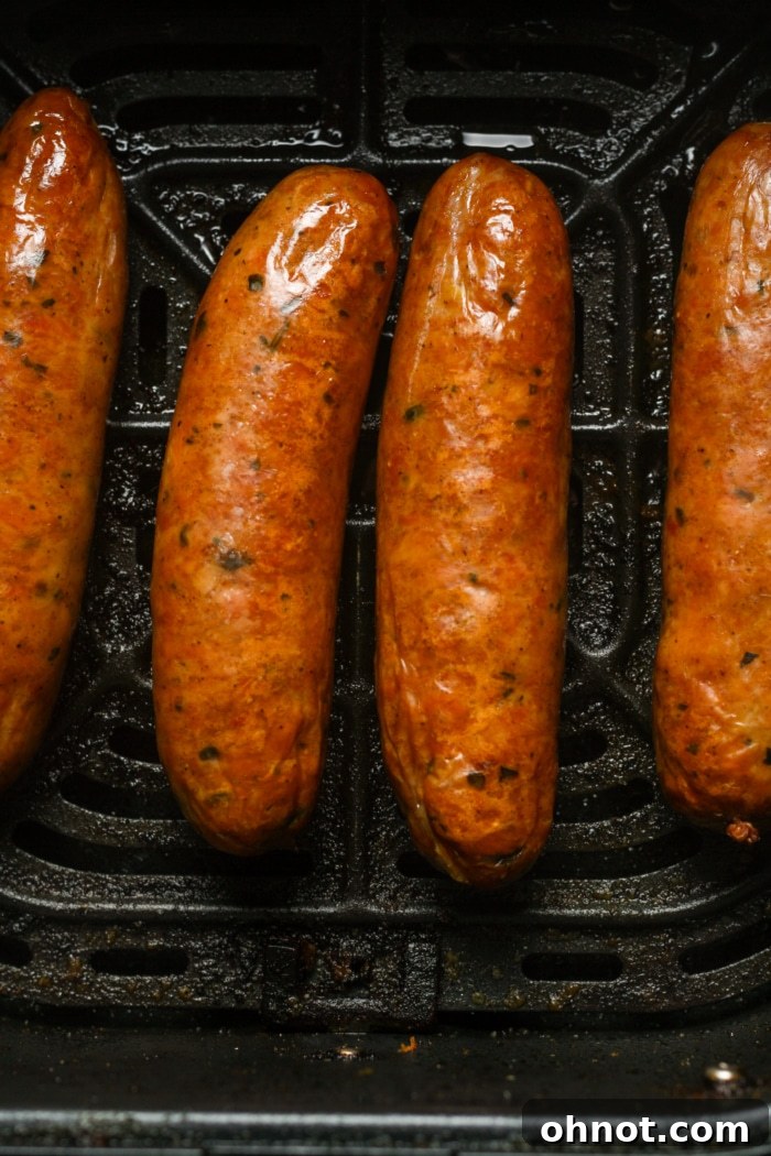 Perfectly cooked and browned Italian sausages removed from the air fryer.