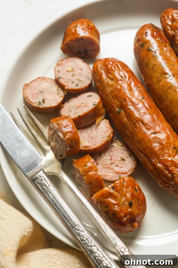 Sliced air-fried Italian sausage on a plate, showcasing the juicy interior.
