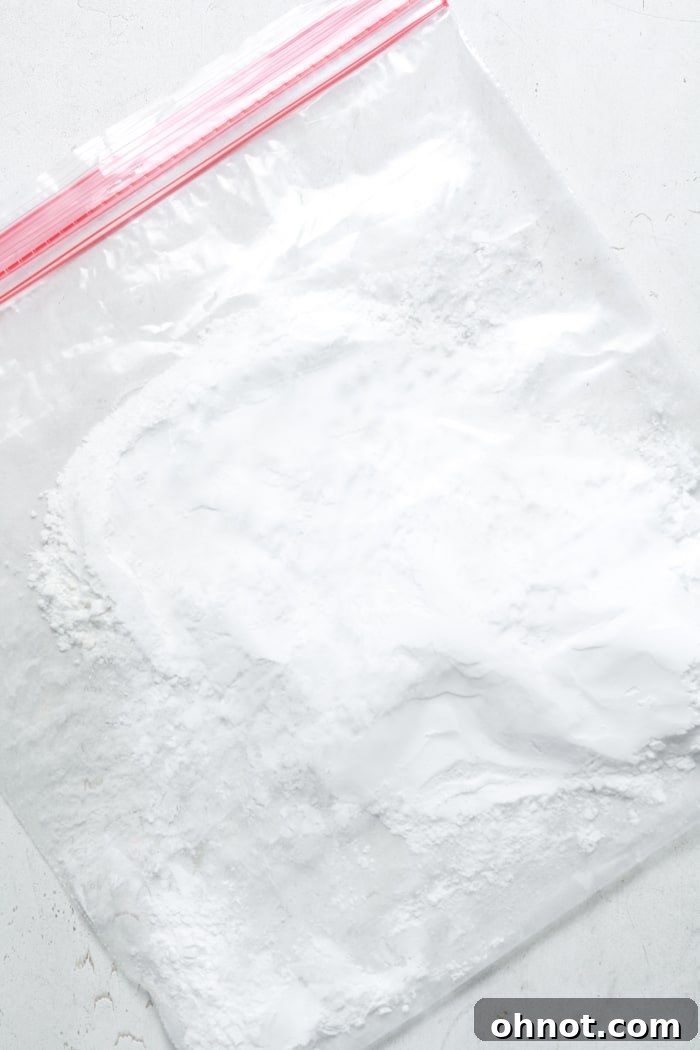 Gluten-free all-purpose flour and tapioca flour mixed inside a large Ziploc bag, ready for coating chicken pieces.