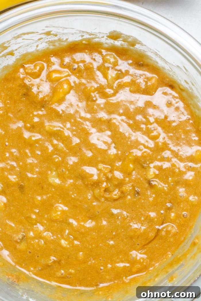 Smooth and creamy banana bread batter in a mixing bowl.