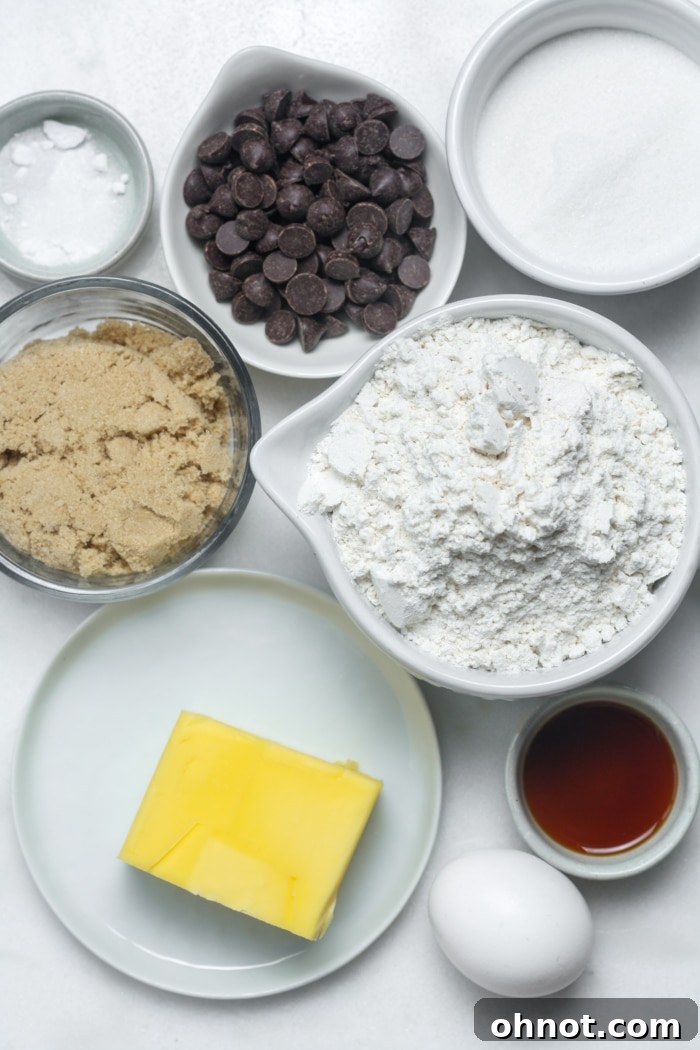 Various ingredients for mini chocolate chip cookies laid out on a surface.