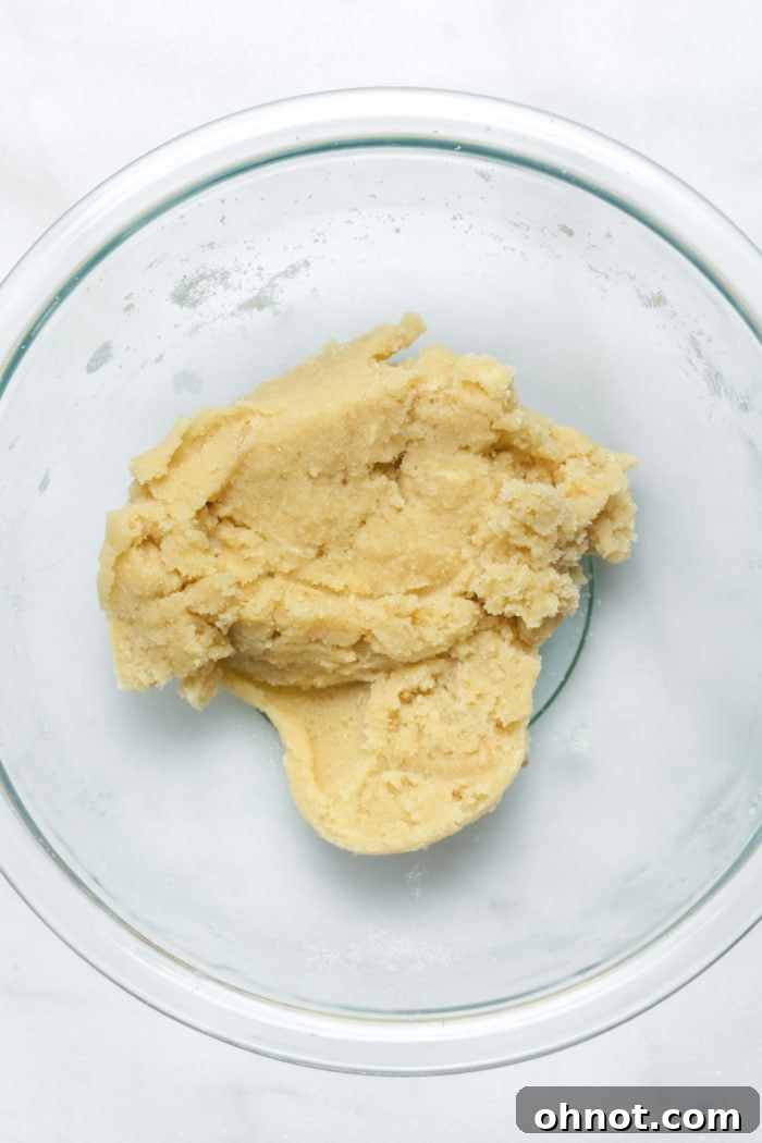 A bowl of beaten butter and sugar, light and fluffy.