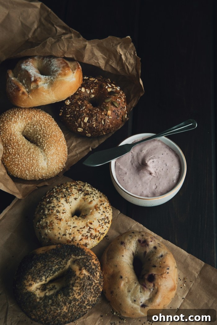 A perfectly toasted bagel generously spread with creamy vegan cream cheese, garnished with fresh herbs, ready for breakfast.