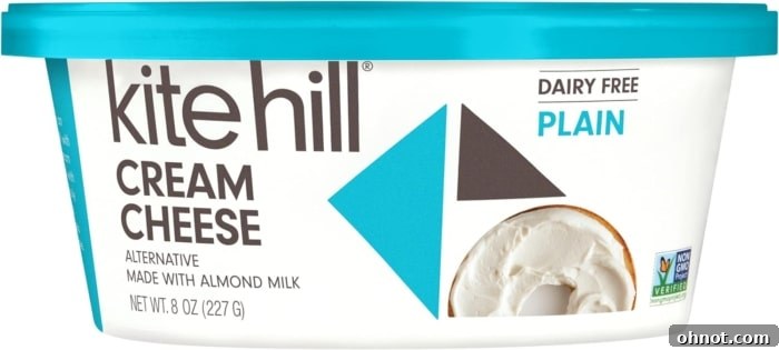 A package of Kite Hill almond milk-based vegan cream cheese, featuring a smooth, white spread.