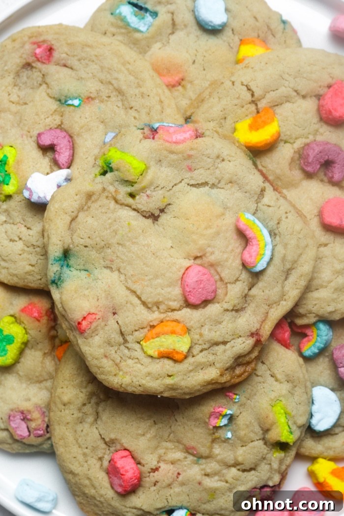 A plate of freshly baked Lucky Charms cookies, vibrant with colorful marshmallows.