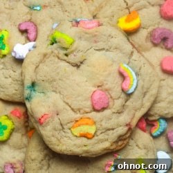 A close-up of a stack of Lucky Charms cookies on a wire rack.