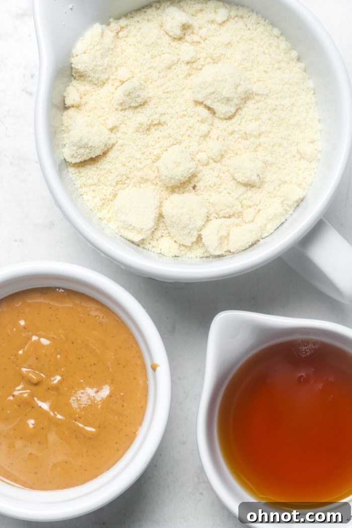 Three key ingredients for gluten-free Nutter Butters: natural peanut butter, maple syrup, and almond flour.
