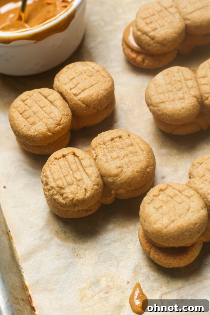 A stack of beautifully assembled homemade nutter butter cookies, showcasing their perfect shape and creamy filling.
