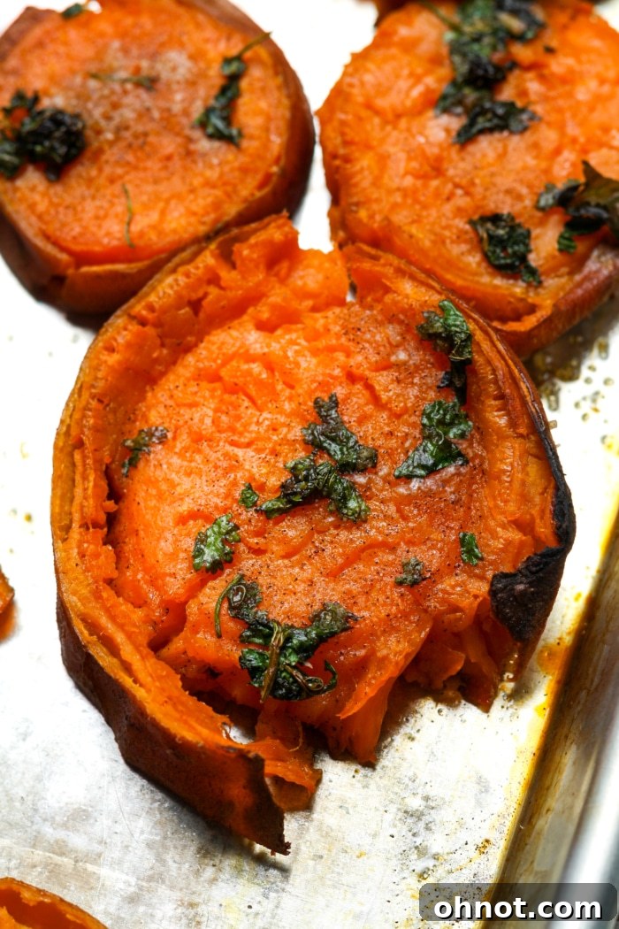 Crispy smashed sweet potato rounds garnished with fresh herbs, a delicious side dish.