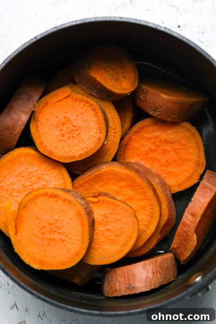 Boiled sweet potato rounds ready for smashing and roasting.