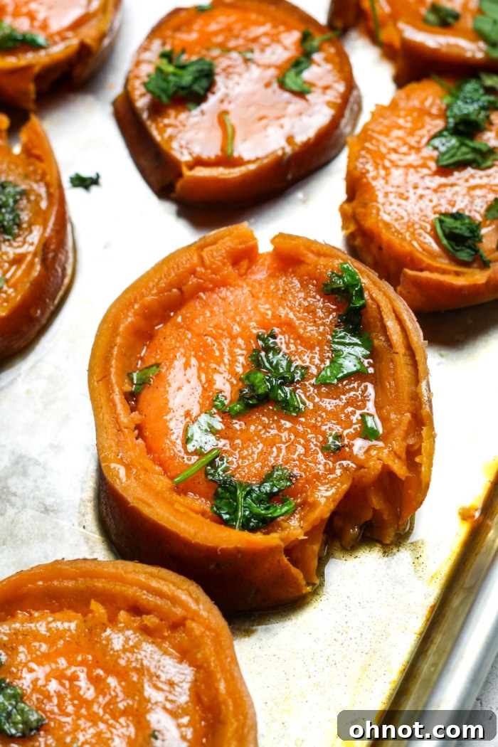 Close-up of buttery, seasoned sweet potato rounds before baking.