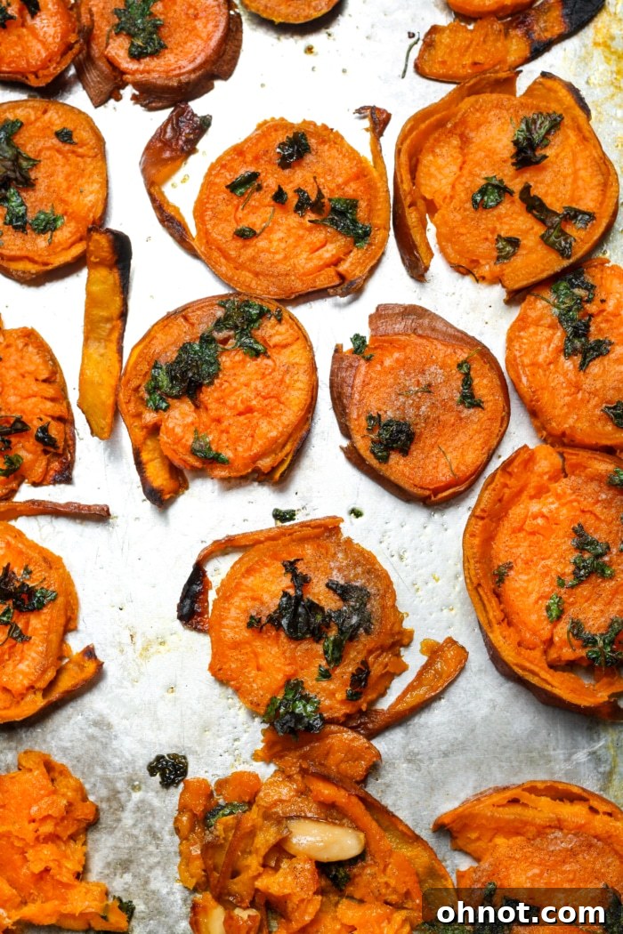 Beautifully baked crispy smashed sweet potatoes, golden brown and garnished.
