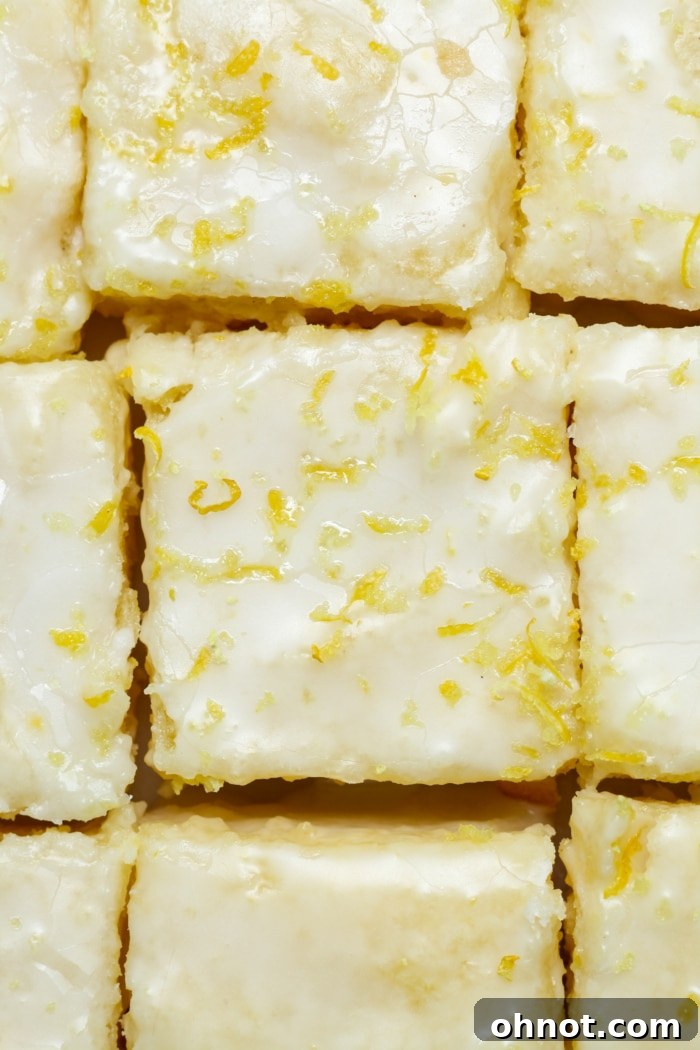 Sliced citrus bars with a delicate glaze on top, presented beautifully on a platter.
