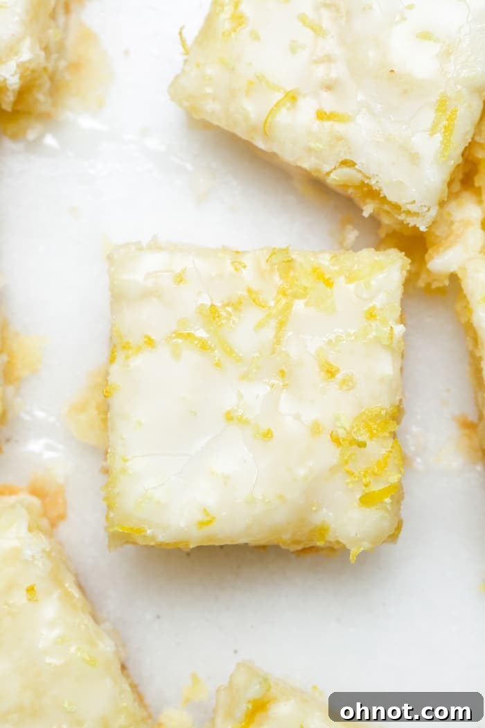 A close-up of vibrant yellow lemon brownies, perfectly sliced and ready to serve.